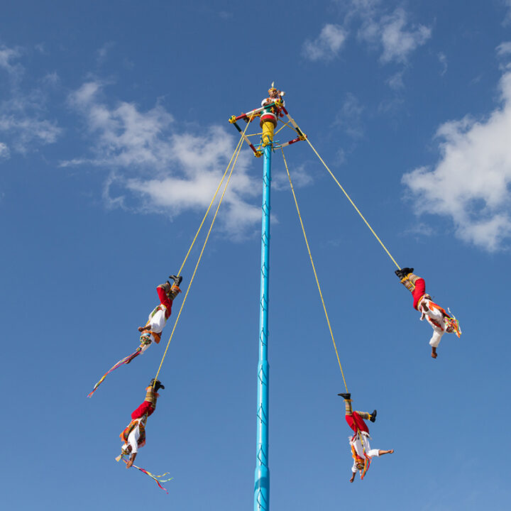 Playa Del Carmen, Quintana Roo Mexico - 04-12-2021: Voladores performing the dance of the flyers ritual. A traditional ceremony in Mexico